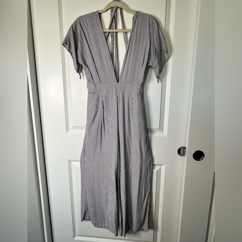 Black and white striped one-piece pant romper with deep V-neck front and back